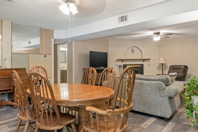 234 Robin Ln, Walnut Ridge, AR 72476 - dining room with ceiling fan, wood finished floors, and a fireplace