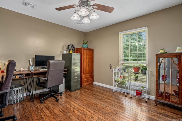office space with a ceiling fan, hardwood / wood-style floors, and baseboards