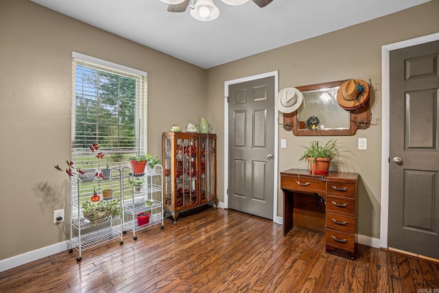 entryway featuring ceiling fan, baseboards, and dark wood-style floors