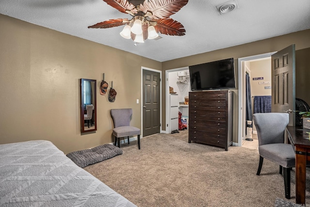 bedroom with light carpet, a ceiling fan, and ensuite bathroom