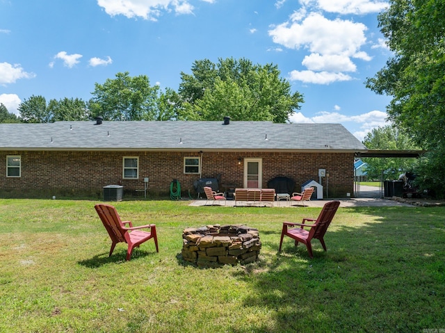 back of property featuring a fire pit, a gate, central AC, brick siding, and a patio