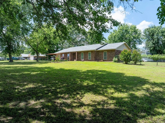 view of front of property with a front lawn and brick siding
