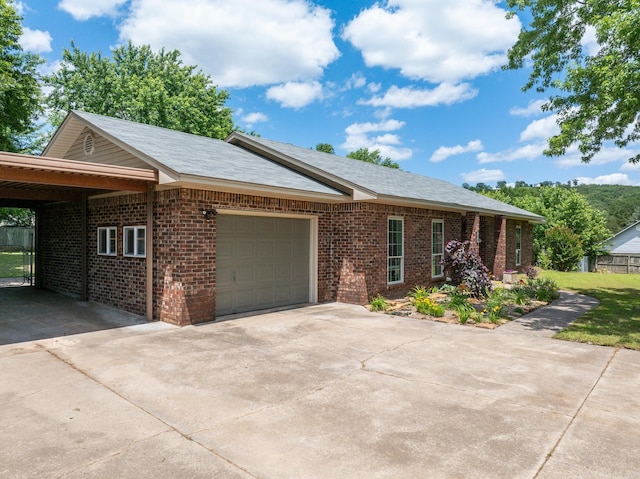 ranch-style house featuring driveway, an attached garage, and brick siding