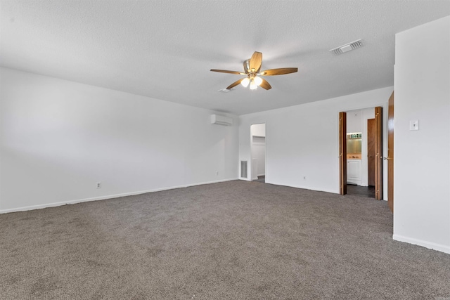 6500 W 12th St, Little Rock, AR 72204 - empty room with a wall unit AC, a ceiling fan, dark colored carpet, baseboards, and a textured ceiling