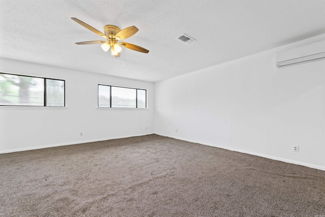 6500 W 12th St, Little Rock, AR 72204 - carpeted spare room with an AC wall unit, a textured ceiling, ceiling fan, and baseboards