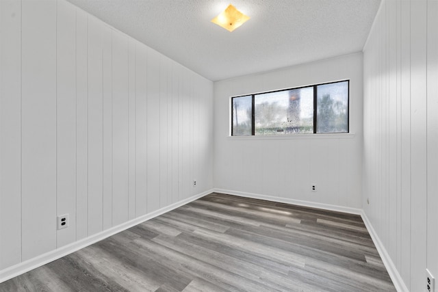 6500 W 12th St, Little Rock, AR 72204 - spare room featuring a textured ceiling and wood finished floors