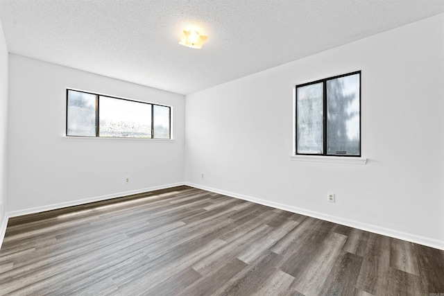 6500 W 12th St, Little Rock, AR 72204 - unfurnished room with wood finished floors, a textured ceiling, and baseboards