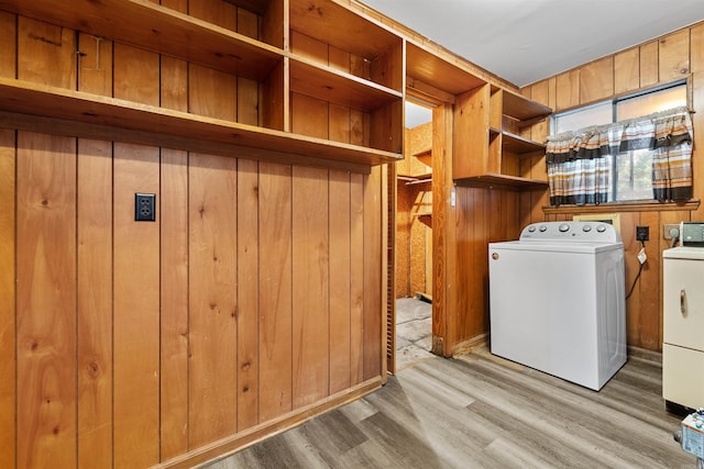 6500 W 12th St, Little Rock, AR 72204 - laundry area with washer and dryer, wood walls, and wood finished floors