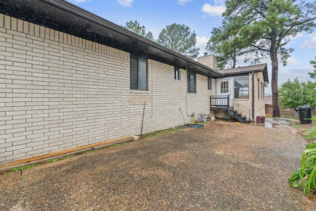 6500 W 12th St, Little Rock, AR 72204 - view of home's exterior with brick siding and a chimney