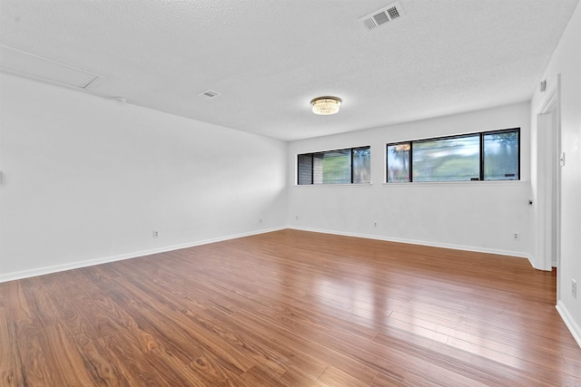6500 W 12th St, Little Rock, AR 72204 - spare room featuring a textured ceiling, wood finished floors, and baseboards