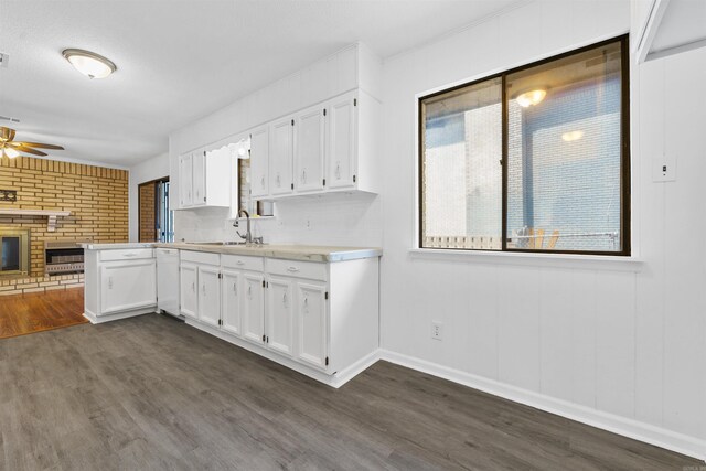 6500 W 12th St, Little Rock, AR 72204 - kitchen featuring a sink, dark wood-style flooring, ceiling fan, light countertops, and white cabinetry