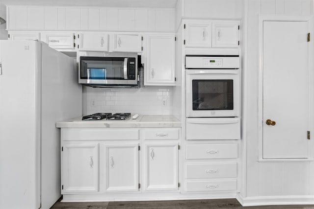 6500 W 12th St, Little Rock, AR 72204 - kitchen with white appliances, a warming drawer, and white cabinets