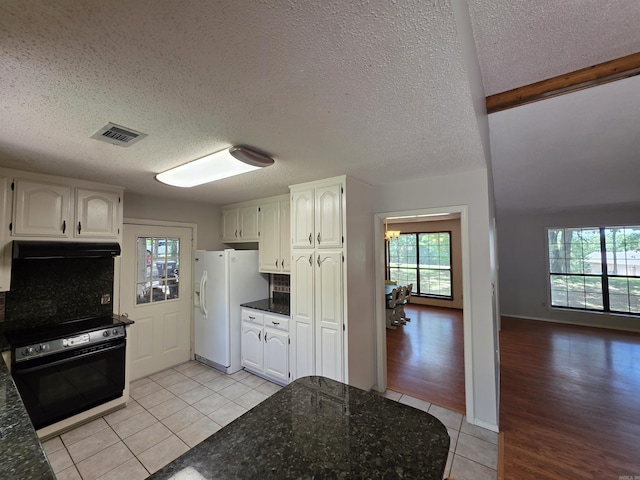 535 Ridgeview Ln, Russellville, AR 72802 - kitchen with wall oven, white fridge with ice dispenser, light tile patterned floors, white cabinetry, and a textured ceiling