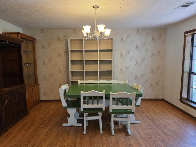 535 Ridgeview Ln, Russellville, AR 72802 - dining space featuring wood finished floors, a chandelier, a textured ceiling, baseboards, and wallpapered walls