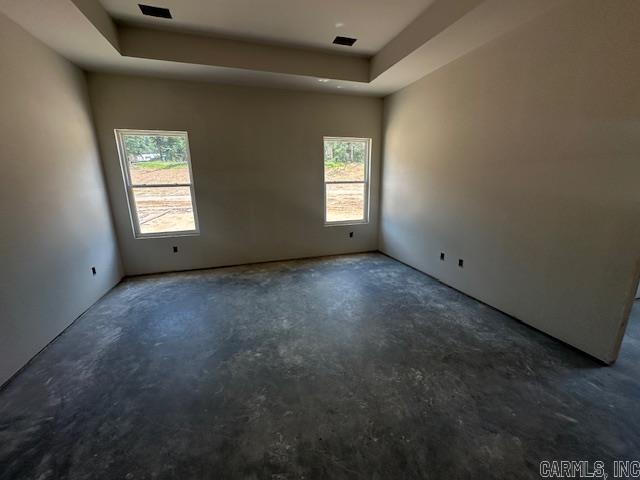 1168 Duke Dr, Bauxite, AR 72011 - empty room featuring unfinished concrete flooring and a raised ceiling