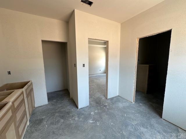1168 Duke Dr, Bauxite, AR 72011 - unfurnished bedroom with a closet, concrete floors, and a spacious closet