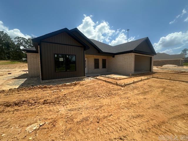 1168 Duke Dr, Bauxite, AR 72011 - view of front of house featuring an attached garage and brick siding