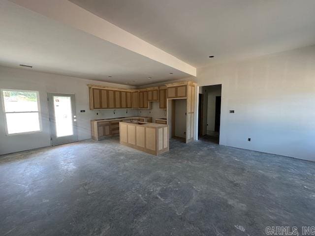 1168 Duke Dr, Bauxite, AR 72011 - kitchen with unfinished concrete floors, a kitchen island, open floor plan, and light brown cabinets