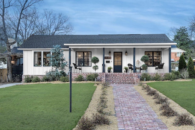 2803 Dalewood Rd, Little Rock, AR 72207 - view of front facade featuring a porch, board and batten siding, a front yard, and a shingled roof