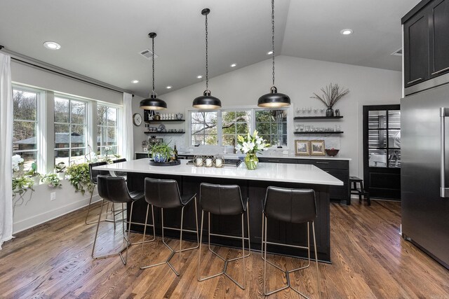 2803 Dalewood Rd, Little Rock, AR 72207 - kitchen featuring open shelves, stainless steel fridge, light countertops, lofted ceiling, and a kitchen island