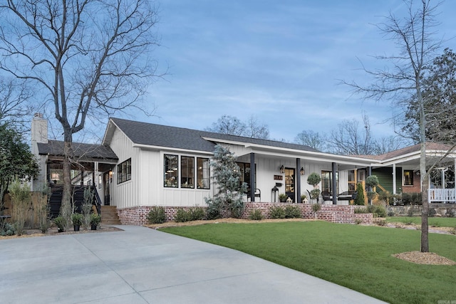 2803 Dalewood Rd, Little Rock, AR 72207 - view of front of property featuring a porch, a front yard, a shingled roof, and board and batten siding