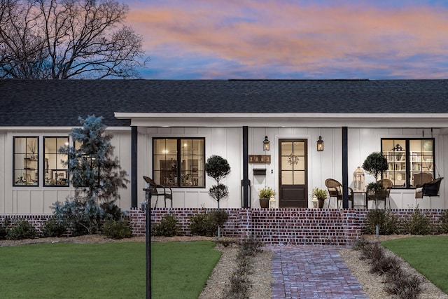 2803 Dalewood Rd, Little Rock, AR 72207 - view of front of home featuring covered porch, board and batten siding, roof with shingles, and a front yard
