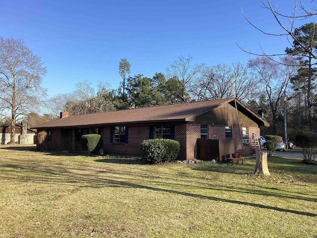 228 Nevada 66 W, Prescott, AR 71857 - view of home's exterior featuring brick siding, a lawn, and a chimney