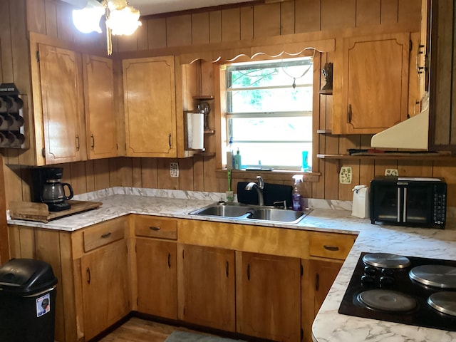 228 Nevada 66 W, Prescott, AR 71857 - kitchen featuring a sink, light countertops, black electric stovetop, a chandelier, and brown cabinetry