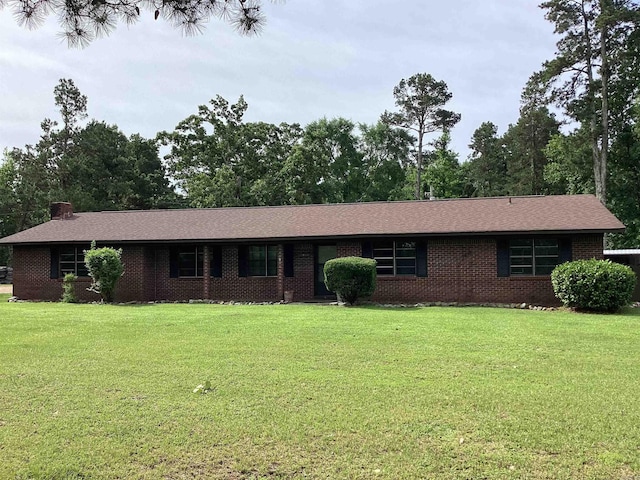 228 Nevada 66 W, Prescott, AR 71857 - ranch-style house with a front yard, brick siding, and a chimney