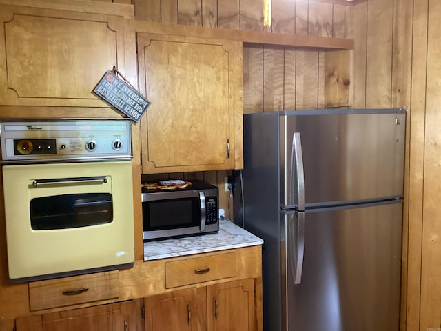 228 Nevada 66 W, Prescott, AR 71857 - kitchen featuring stainless steel appliances, brown cabinetry, and light countertops
