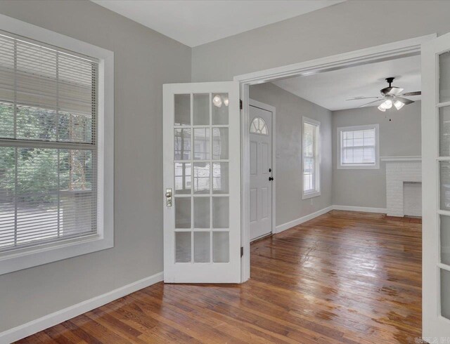 122 Kenwood St, Hot Springs, AR 71913 - foyer entrance featuring wood-type flooring, baseboards, ceiling fan, and a fireplace