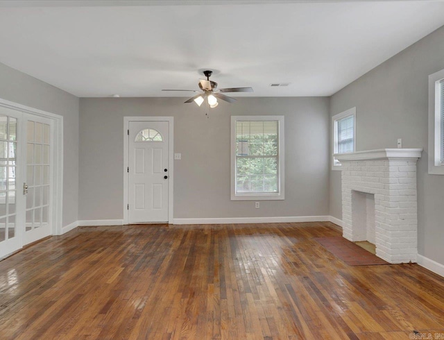 122 Kenwood St, Hot Springs, AR 71913 - unfurnished living room featuring baseboards, hardwood / wood-style flooring, a ceiling fan, and a fireplace