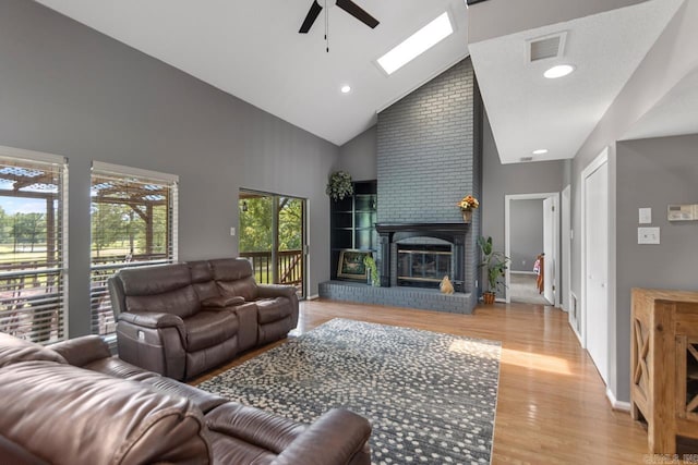 38 Ninth Fairway Loop, Maumelle, AR 72113 - living room with high vaulted ceiling, a ceiling fan, light wood finished floors, and a fireplace