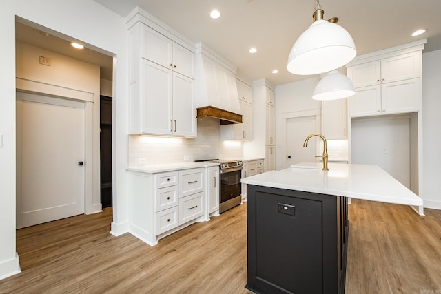 57 Republican Loop, Greenbrier, AR 72058 - kitchen featuring stainless steel electric stove, a sink, white cabinets, light wood finished floors, and decorative backsplash