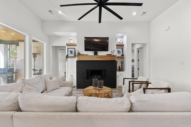 2505 Collins Dr, Conway, AR 72058 - living area with ceiling fan, a fireplace, light wood-style floors, and recessed lighting