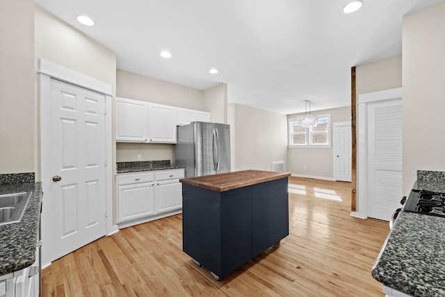 212 Barton St, Little Rock, AR 72205 - kitchen with freestanding refrigerator, wooden counters, white cabinetry, light wood-style floors, and recessed lighting