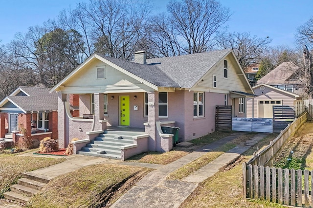 212 Barton St, Little Rock, AR 72205 - bungalow featuring brick siding, driveway, covered porch, an outdoor structure, and roof with shingles