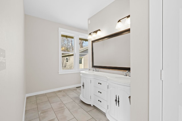 212 Barton St, Little Rock, AR 72205 - bathroom featuring double vanity, tile patterned flooring, and baseboards
