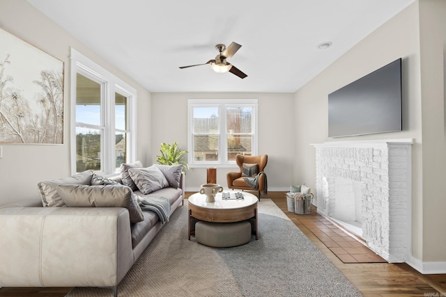 212 Barton St, Little Rock, AR 72205 - living room featuring ceiling fan, a brick fireplace, wood finished floors, and baseboards