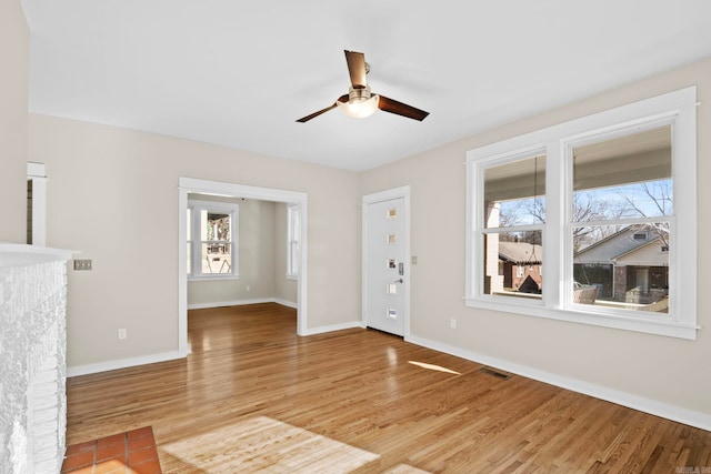212 Barton St, Little Rock, AR 72205 - unfurnished living room featuring ceiling fan, plenty of natural light, and light wood-type flooring