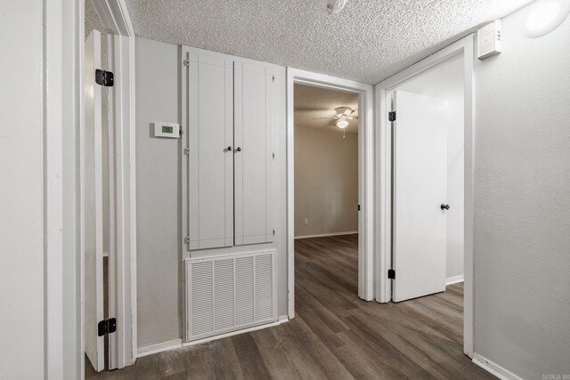 1716 Walnut St, Arkadelphia, AR 71923 - corridor featuring baseboards, a textured ceiling, and dark wood-style flooring