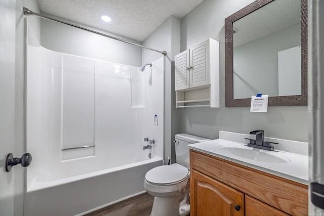1716 Walnut St, Arkadelphia, AR 71923 - bathroom with a textured ceiling, toilet, bathing tub / shower combination, vanity, and wood finished floors