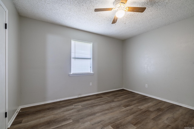 1716 Walnut St, Arkadelphia, AR 71923 - empty room with dark wood-style floors, a textured ceiling, a ceiling fan, and baseboards