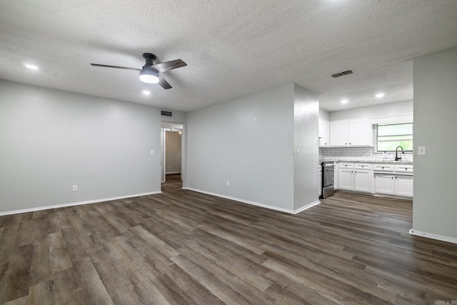 1716 Walnut St, Arkadelphia, AR 71923 - unfurnished living room with dark wood-style flooring, ceiling fan, baseboards, a textured ceiling, and a sink