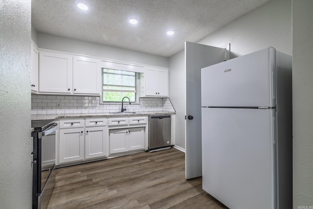 1716 Walnut St, Arkadelphia, AR 71923 - kitchen featuring freestanding refrigerator, black electric range oven, a sink, stainless steel dishwasher, and tasteful backsplash