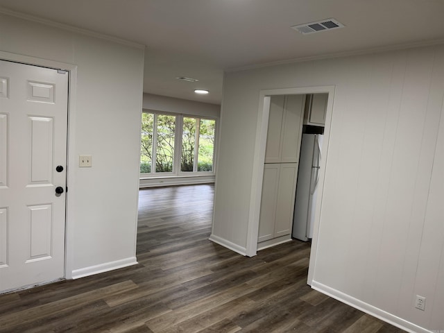 hall featuring baseboards, dark wood-type flooring, and crown molding