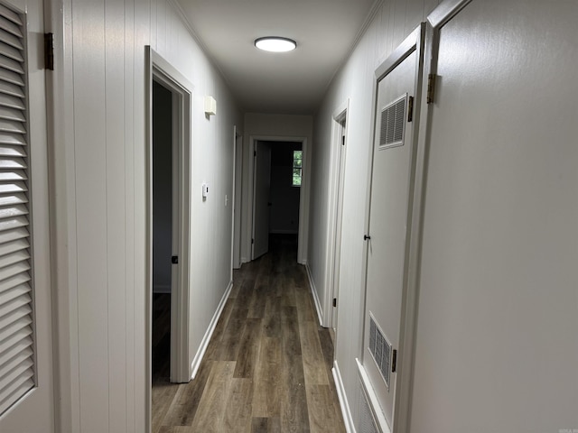 hall featuring wood finished floors and baseboards