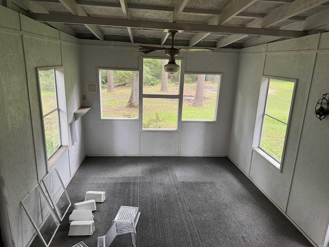 unfurnished sunroom featuring beam ceiling