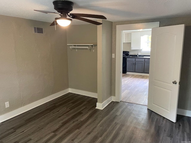 202 Roosevelt, Jacksonville, AR 72076 - unfurnished bedroom with a sink, dark wood-type flooring, baseboards, a closet, and a textured wall