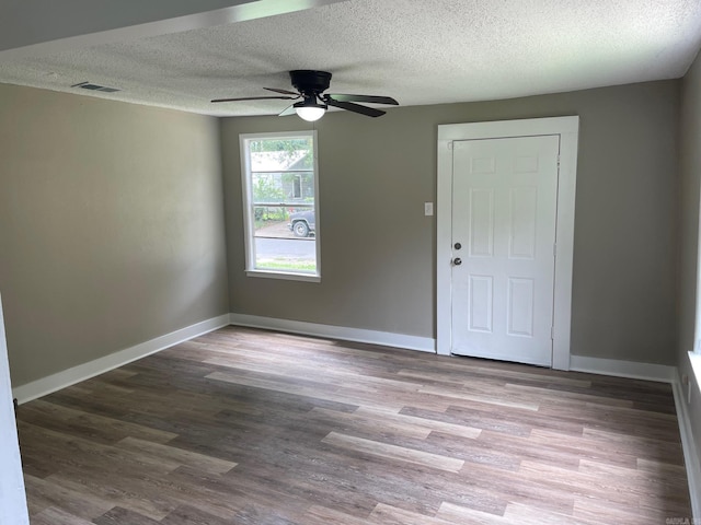 202 Roosevelt, Jacksonville, AR 72076 - spare room featuring a textured ceiling, a ceiling fan, wood finished floors, and baseboards